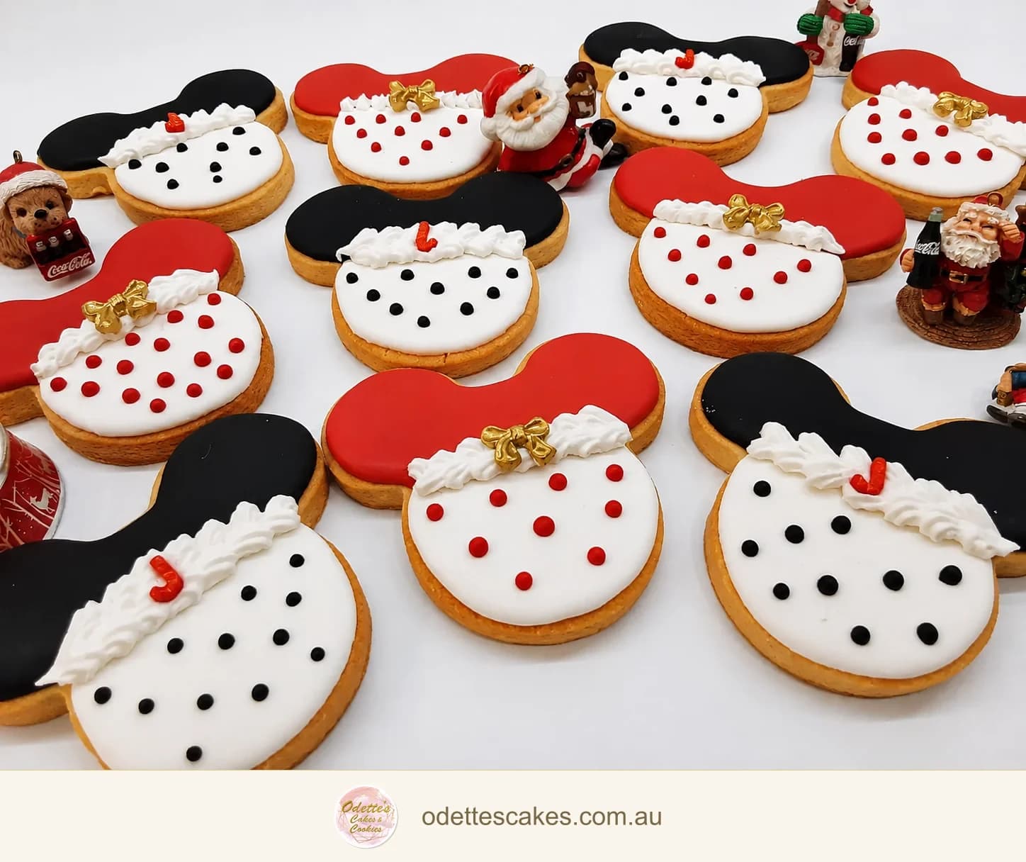 Hand-iced snowman face cookies with red and black hats and piped white details