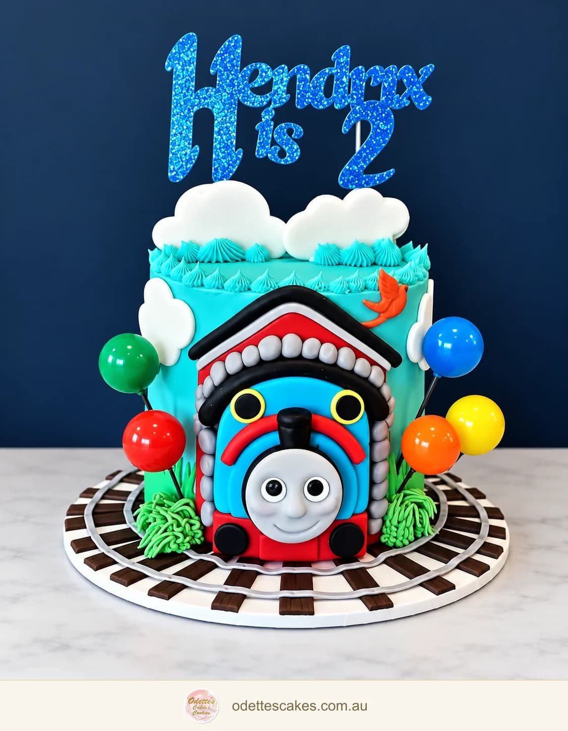 Colourful Thomas the Tank Engine birthday cake with balloons and a railway border