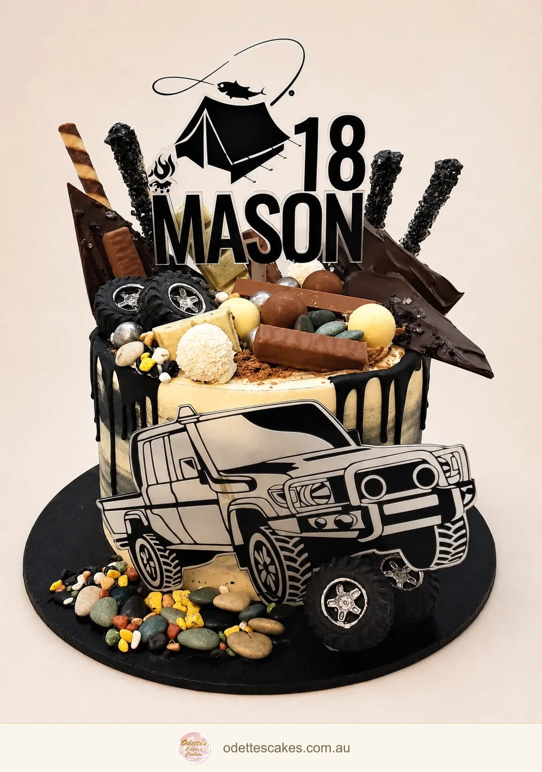 18th birthday cake with chocolate drips, sweets and a black-and-white four-wheel-drive decoration