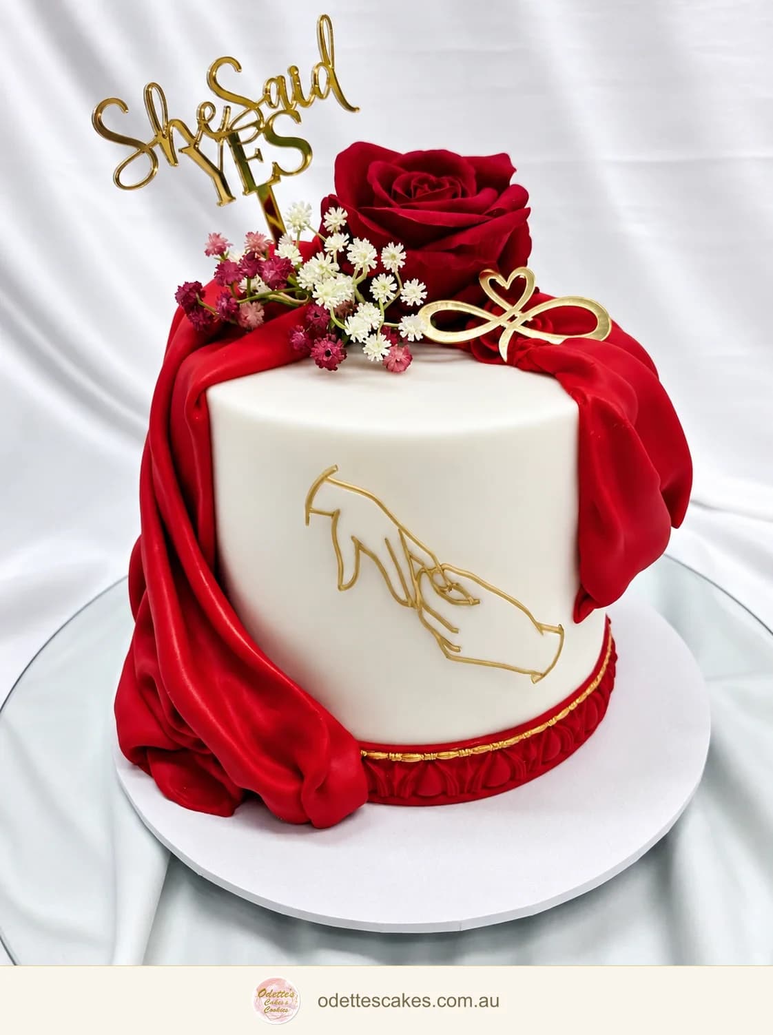 Single tier engagement cake with red fabric and gold highlights
