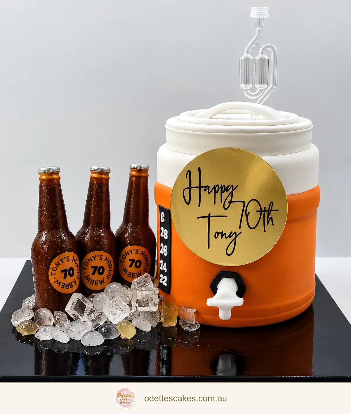 70th birthday cake shaped like a takeaway coffee cup with small bottle and ice decorations
