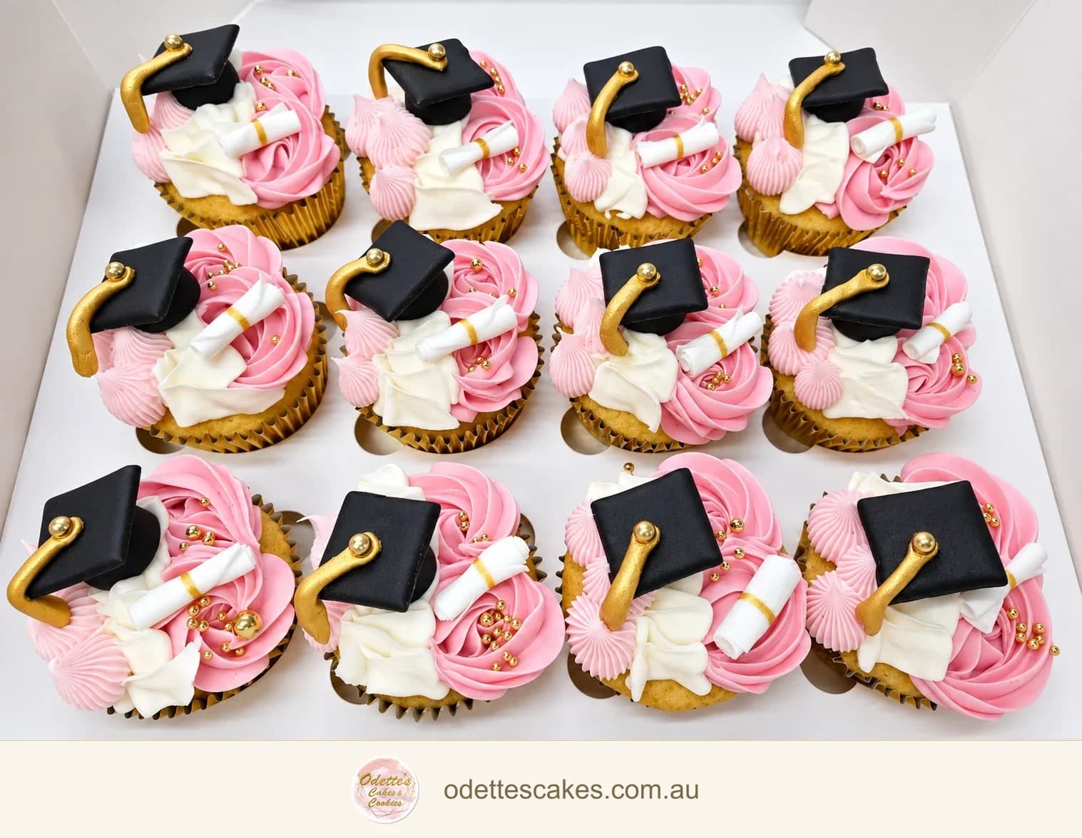 Pink and white graduation cupcakes in gold cases with black mortarboards, gold tassels and miniature diplomas, Jindalee, Perth
