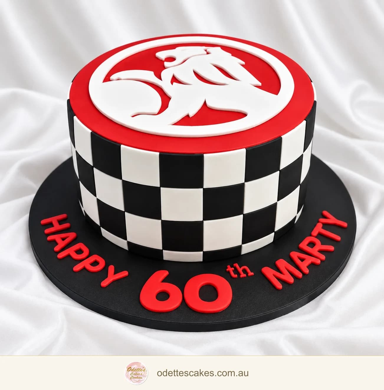 60th birthday cake with a black-and-white chequered pattern and a red Holden emblem