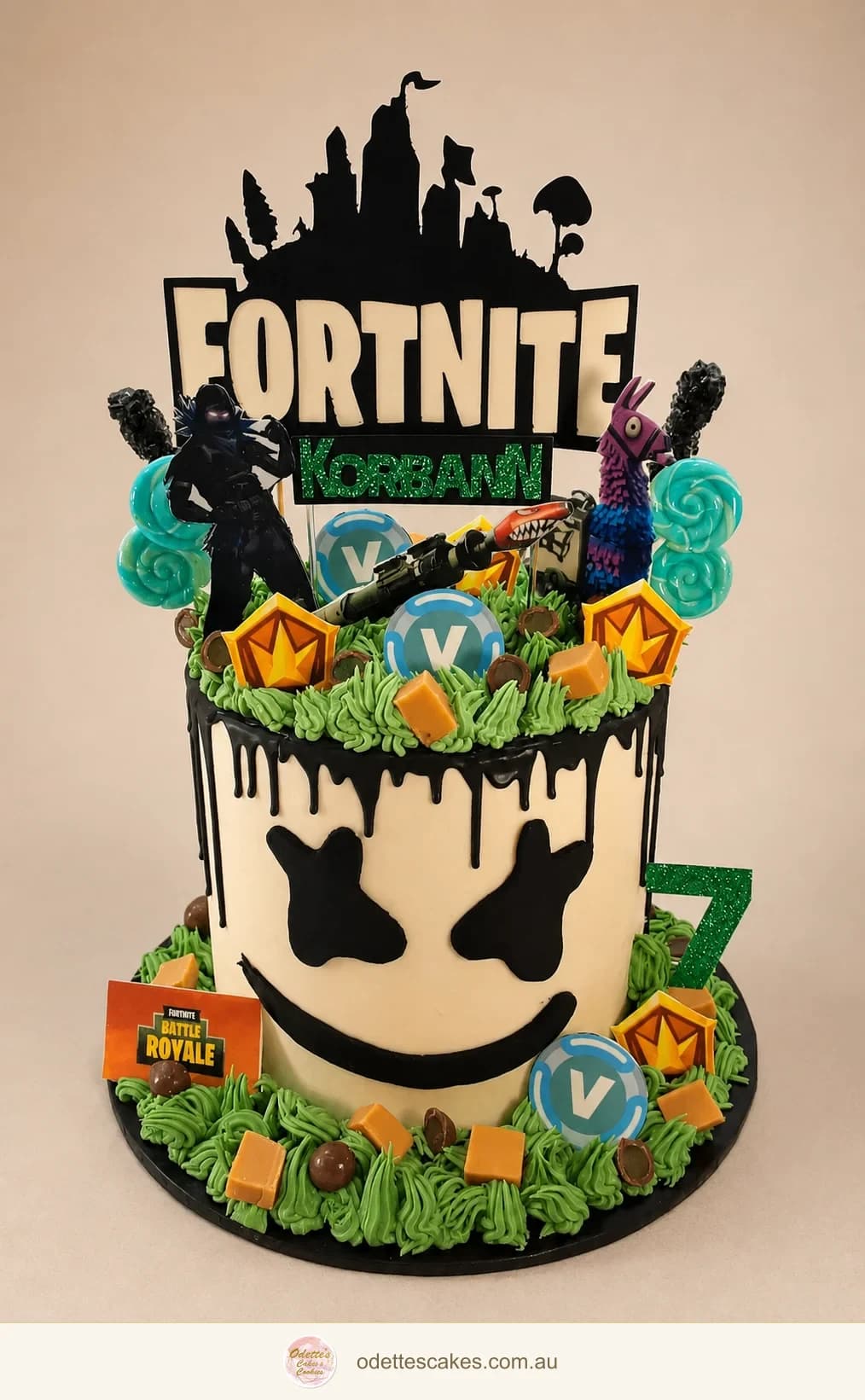 Fortnite-themed birthday cake with black chocolate drips and colourful game decorations