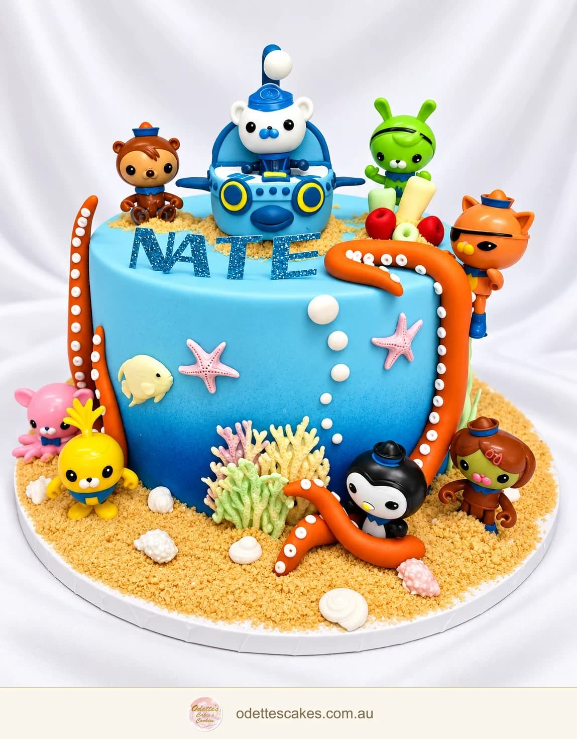 Blue ocean-themed birthday cake with Octonauts figures, a submarine, orange tentacles, coral and shells, handmade in Jindalee, Perth