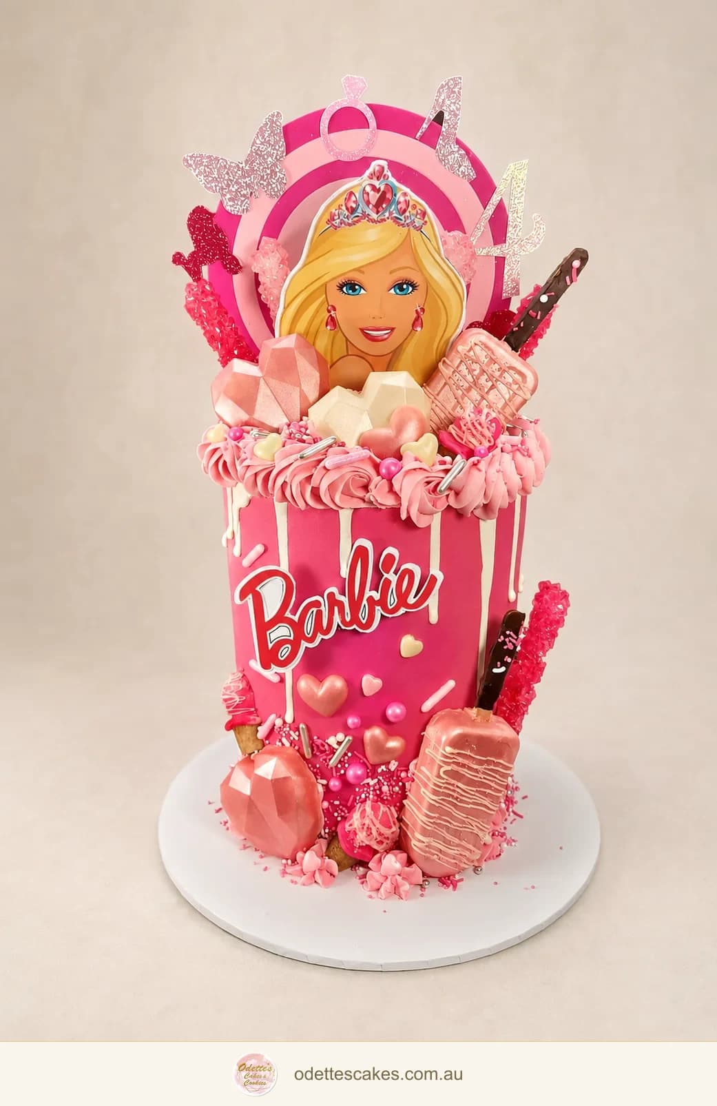 Pink Barbie birthday cake with a doll illustration, chocolate drips, sweets and a number topper