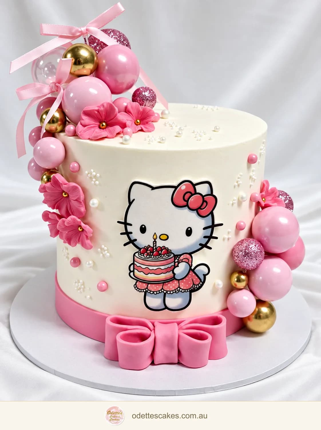 White Hello Kitty birthday cake with pink bows, flowers, pearls and pink and gold spheres, made in Jindalee, Perth