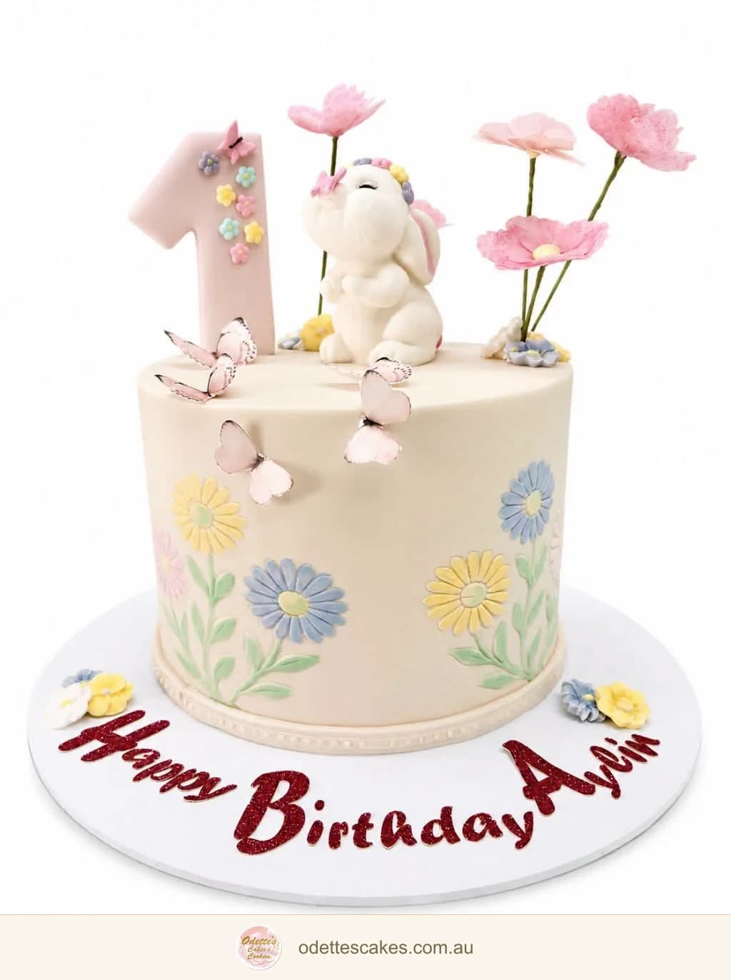 Ivory first birthday cake with a white bunny, pink number one topper, pastel flowers and pink butterflies, handmade in Jindalee, Perth